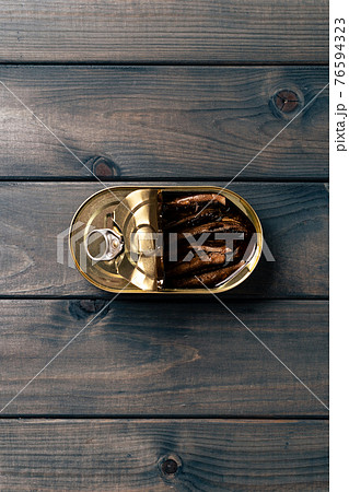 Canned fish in sauce conserve on dark wooden table Canned fish in sauce conserve on dark wooden table 76594323