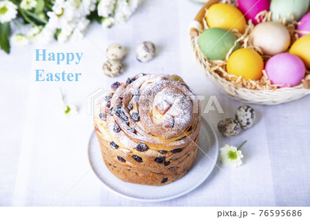 Craffin (Cruffin) with raisins and candied fruits. Easter cake Kulich and painted eggs. Easter Holiday. Close-up. Craffin (Cruffin) with raisins and candied fruits. Easter cake Kulich and painted eggs. Easter Holiday. Close-up. 76595686