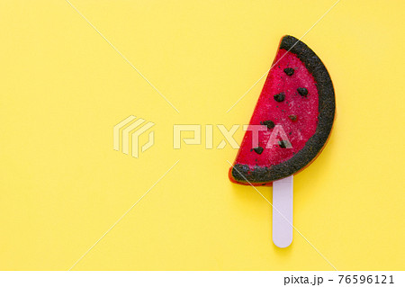 Watermelon popsicle on yellow background. Watermelon popsicle on yellow background. 76596121