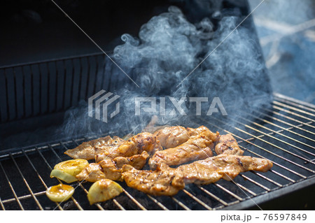Whole Chicken Grilled On Hot Barbecue Charcoal Flaming BBQ grill with lovely meat smoke, concept of grilling 76597849