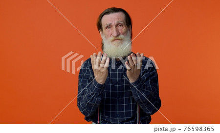 Mature old man praying to God making wish, asking with hopeful imploring expression, begging apology Mature old man praying to God making wish, asking with hopeful imploring expression, begging apology 76598365