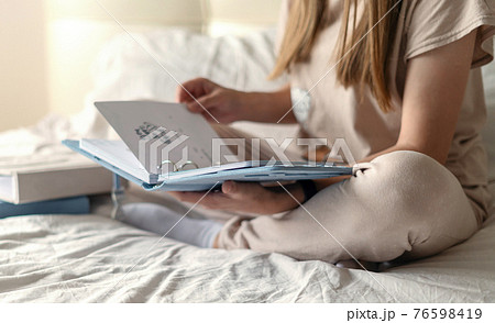 Mother watching a family photo album. 76598419