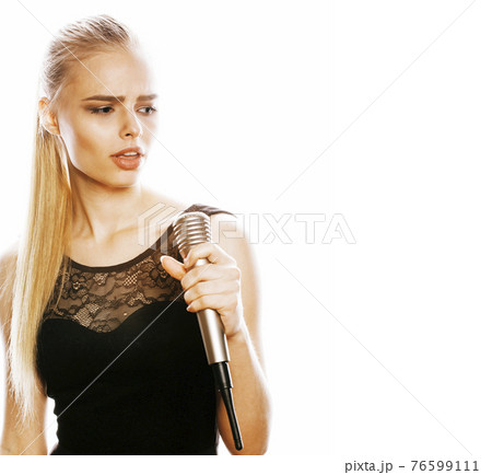 young pretty blond woman singing in microphone isolated close up karaoke 76599111