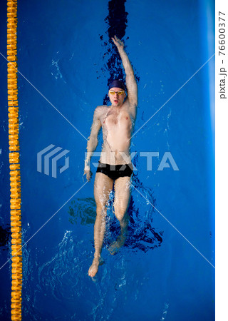 Male professional competitive swimmer in swimming pool, view from above. 76600377