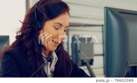 Business people wearing headset working in office Business people wearing headset working in office 76602089