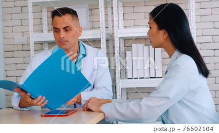 Doctor in professional uniform examining patient at hospital 76602104