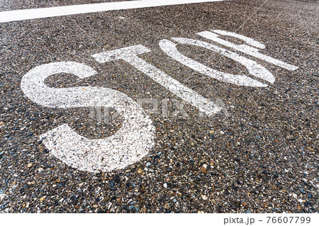 STOP a large inscription on the asphalt in full screen 76607799