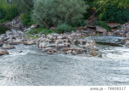 stones in the river near the dam. photo 76608317