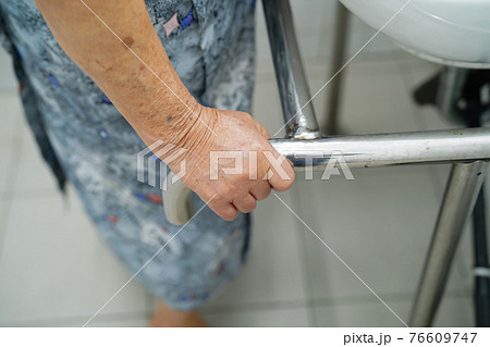 Asian senior or elderly old lady woman patient use toilet bathroom handle security in nursing hospital ward 76609747