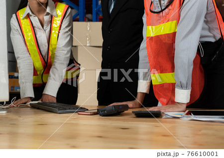 Warehouse manager and worker working in the storehouse Warehouse manager and worker working in the storehouse 76610001
