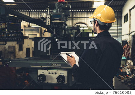 Skillful factory worker working with clipboard to do job procedure checklist . Skillful factory worker working with clipboard to do job procedure checklist . 76610002