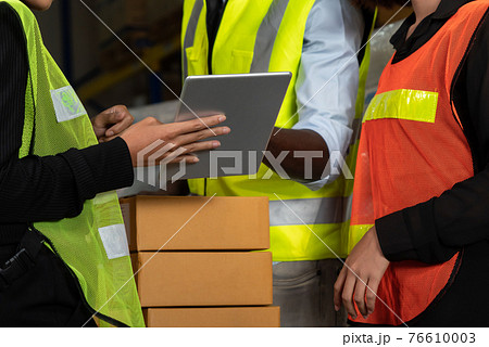 Warehouse worker working together in the storehouse Warehouse worker working together in the storehouse 76610003