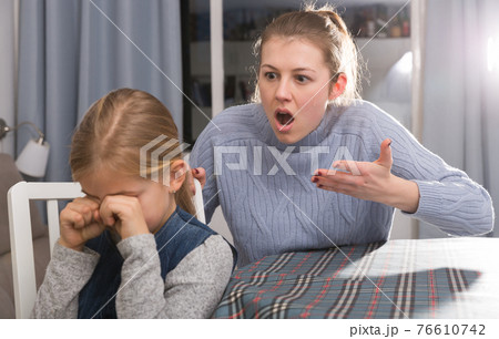 Dissatisfied mother scolds little girl 76610742