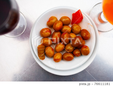 White plate with delicious pitted olives White plate with delicious pitted olives 76611181