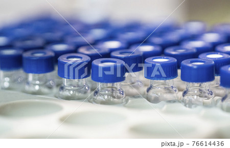 Coronavirus vaccine: covid-19 bottle vaccination. Coronavirus vaccine: covid-19 vaccine bottle vaccination and syringe to inject the vaccine. Vial bottle with syringe. Vaccination concept 76614436