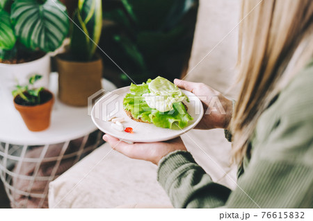 Woman choosing pills healthy food 76615832