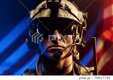 Portrait of special forces soldier in glasses and helmet against US national flag Portrait of special forces soldier in glasses and helmet against US national flag 76617746