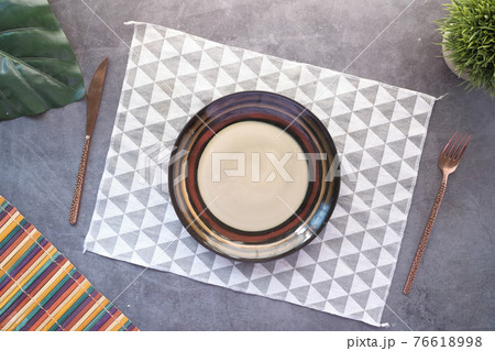 cutlery and empty plate on wooden background top down 76618998
