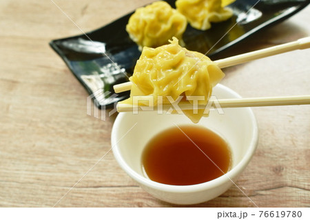 steamed Chinese dumpling stuffed mashed pork dipping soy sauce on plate 76619780