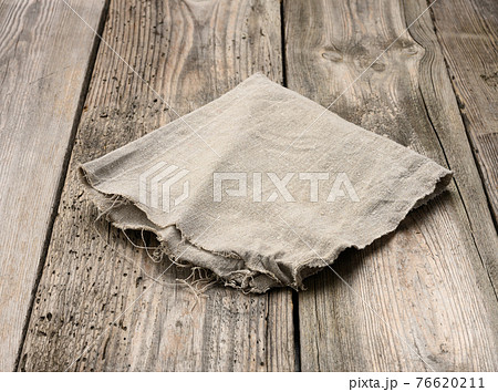 gray linen kitchen towel on a table made of old wooden boards 76620211