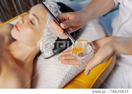 Professional beautician woman stirring mask in 76620635