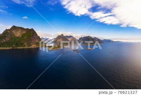 Reine fishing village surrounded by high mountains on Lofoten islands 76621327