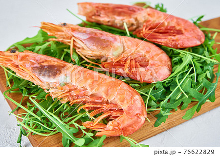 Red raw prawns, close up. Fresh shrimps with rucola. Seafood background 76622829