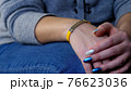 Female hand with vaccined bracelet or label after injection 76623036