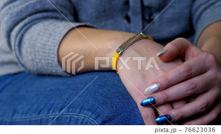Female hand with vaccined bracelet or label after injection 76623036