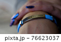 Female hand with vaccined bracelet or label after injection 76623037