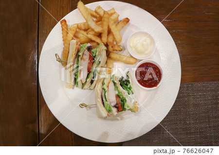 chicken and ham sandwich, club sandwich with French fries chicken and ham sandwich, club sandwich with French fries 76626047