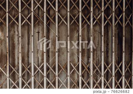 Old grunge rusty shutter folding door for shop closed or business down concept, texture pattern or steel gate. 76626682
