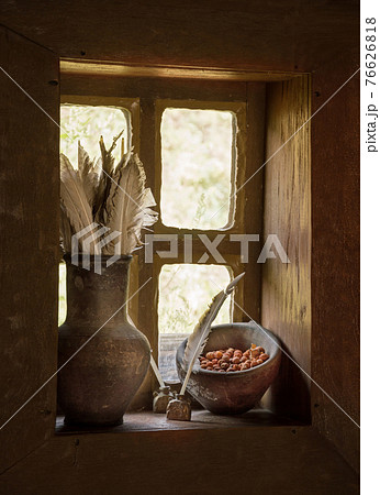 Vintage stilllife with feathers in jug and berries on window Vintage stilllife with feathers in jug and berries on window 76626818