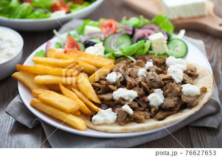 Greek Gyros with Fries and Salad on a Plate. 76627653