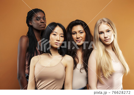 young pretty asian, caucasian, afro woman posing cheerful together on brown background, lifestyle diverse nationality people concept 76628272