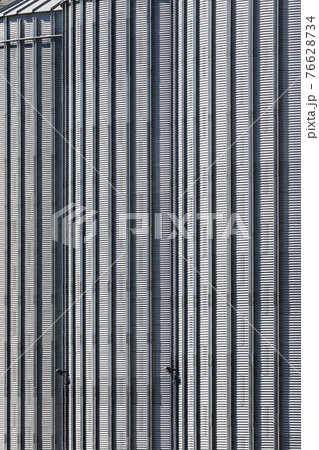 The corrugated steel sides of a storage silo at a flour mill The corrugated steel sides of a storage silo at a flour mill 76628734