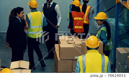 Many people , workers and manger work in warehouse or storehouse Many people , workers and manger work in warehouse or storehouse 76629053