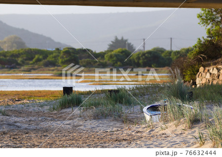 Small Boat Stranded On Sandy Coastal Riverbank Small Boat Stranded On Sandy Coastal Riverbank 76632444