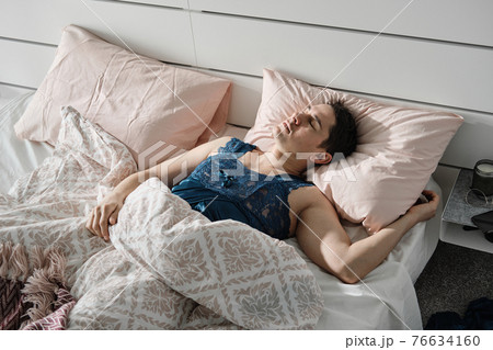 Man relaxing in his bed 76634160