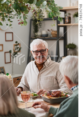 Senior man having dinner 76634748