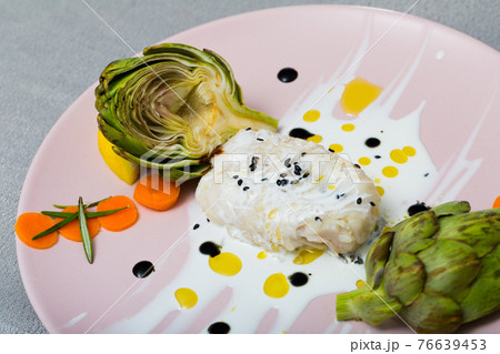 Tasty fillet of horse-mackerel with artichokes and sauce on plate Tasty fillet of horse-mackerel with artichokes and sauce on plate 76639453