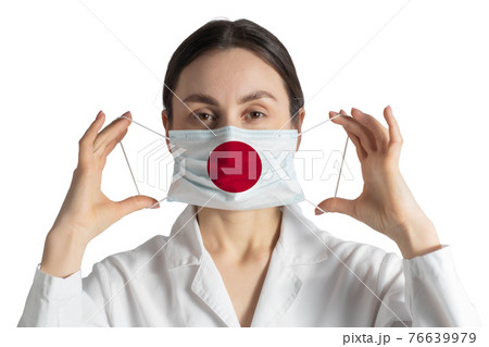 Respirator with flag of Japan Doctor puts on medical face mask isolated on white background Respirator with flag of Japan Doctor puts on medical face mask isolated on white background 76639979