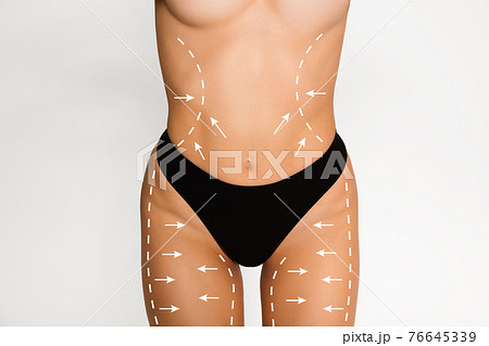 Cropped slim female body in black underwear isolated over white background. Cropped slim female body in black underwear isolated over white background. 76645339