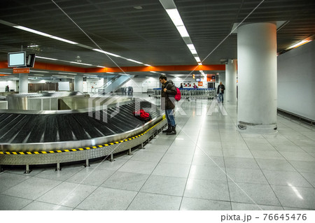 Tourist going to take his baggage 76645476