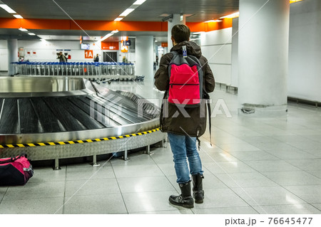 Tourist going to take his baggage 76645477