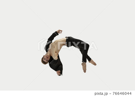 Man in casual style clothes jumping and dancing isolated on white background. Art, motion, action, flexibility, inspiration concept. Flexible caucasian ballet dancer. Man in casual style clothes jumping and dancing isolated on white background. Art, motion, action, flexibility, inspiration concept. Flexible caucasian ballet dancer. 76646044
