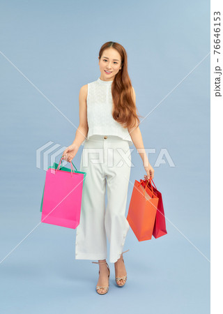Happy Attractive Asian Woman smile and enjoy with shopping bags Happy Attractive Asian Woman smile and enjoy with shopping bags 76646153