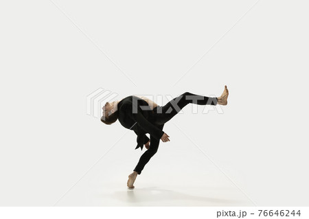 Man in casual style clothes jumping and dancing isolated on white background. Art, motion, action, flexibility, inspiration concept. Flexible caucasian ballet dancer. Man in casual style clothes jumping and dancing isolated on white background. Art, motion, action, flexibility, inspiration concept. Flexible caucasian ballet dancer. 76646244