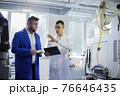 Engineer and technician discussing production process at factory 76646435