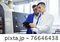 Engineer and technician discussing production process at factory 76646438